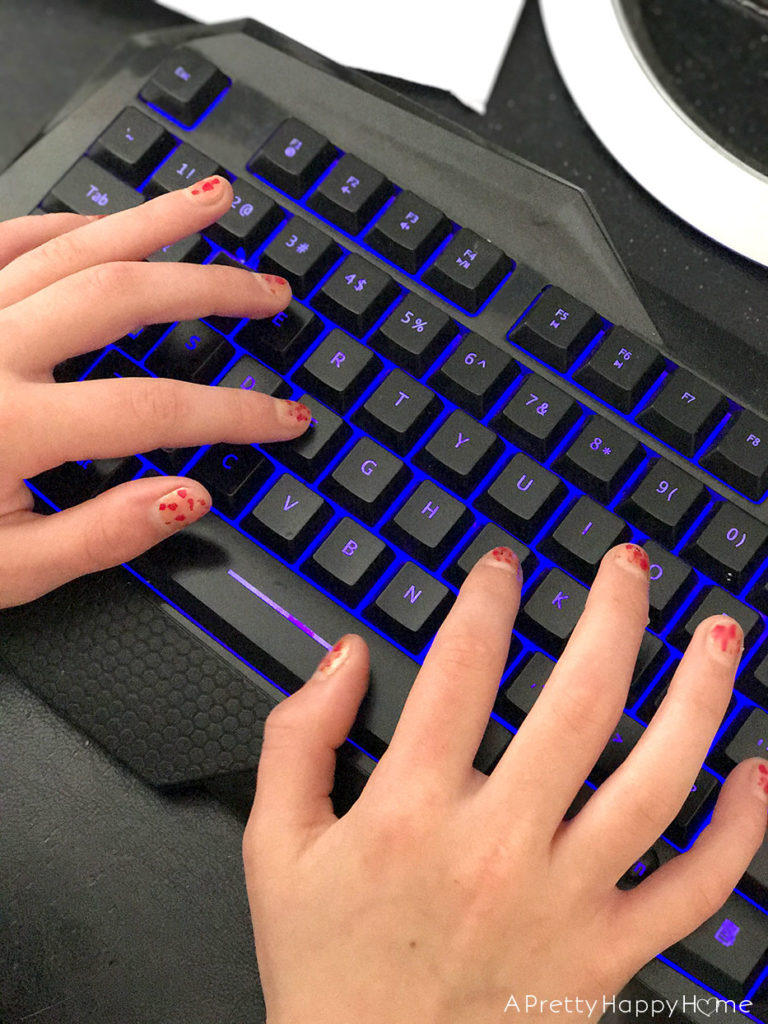 kid typing on keyboard on the happy list