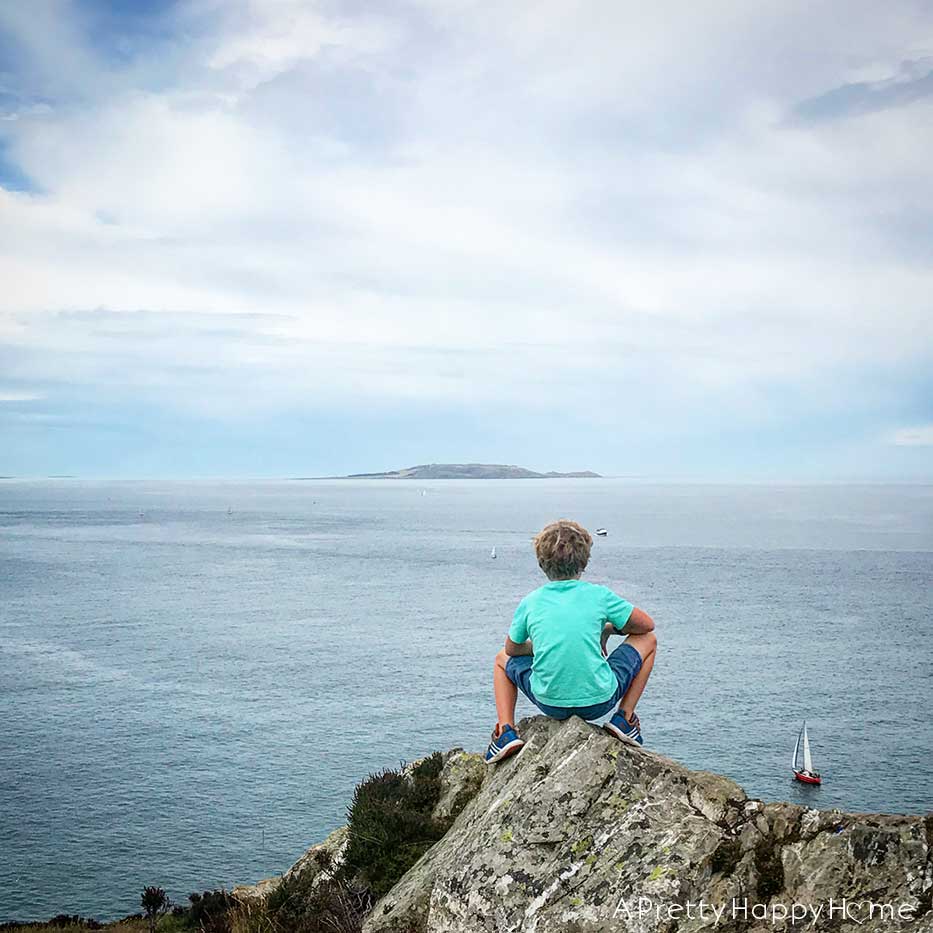 howth head ireland boy looking at irish sea on the happy list