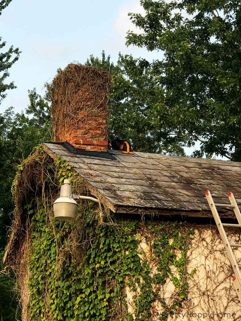 old slate roof before installing a black metal roof carriage house