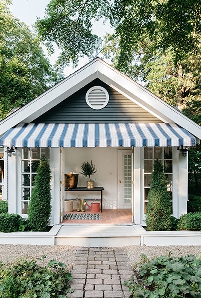 Photographed by Margaret Rajic for Kate Marker Interiors guest house with blue and white awning via lonny on the happy list