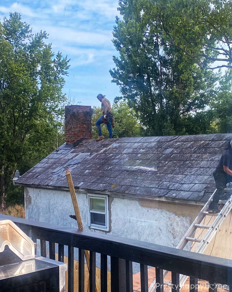 removing a slate roof to install black metal roof carriage house