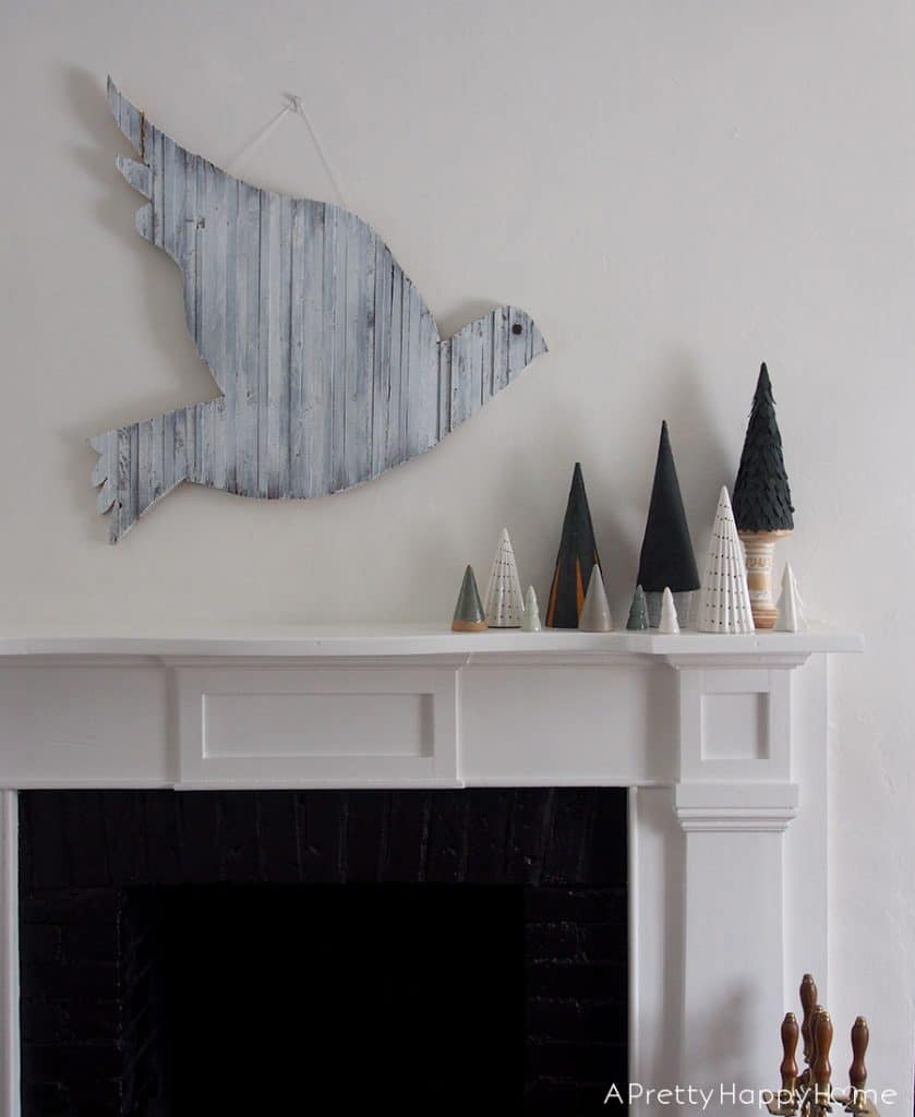 wood dove over mantel and leather Christmas trees