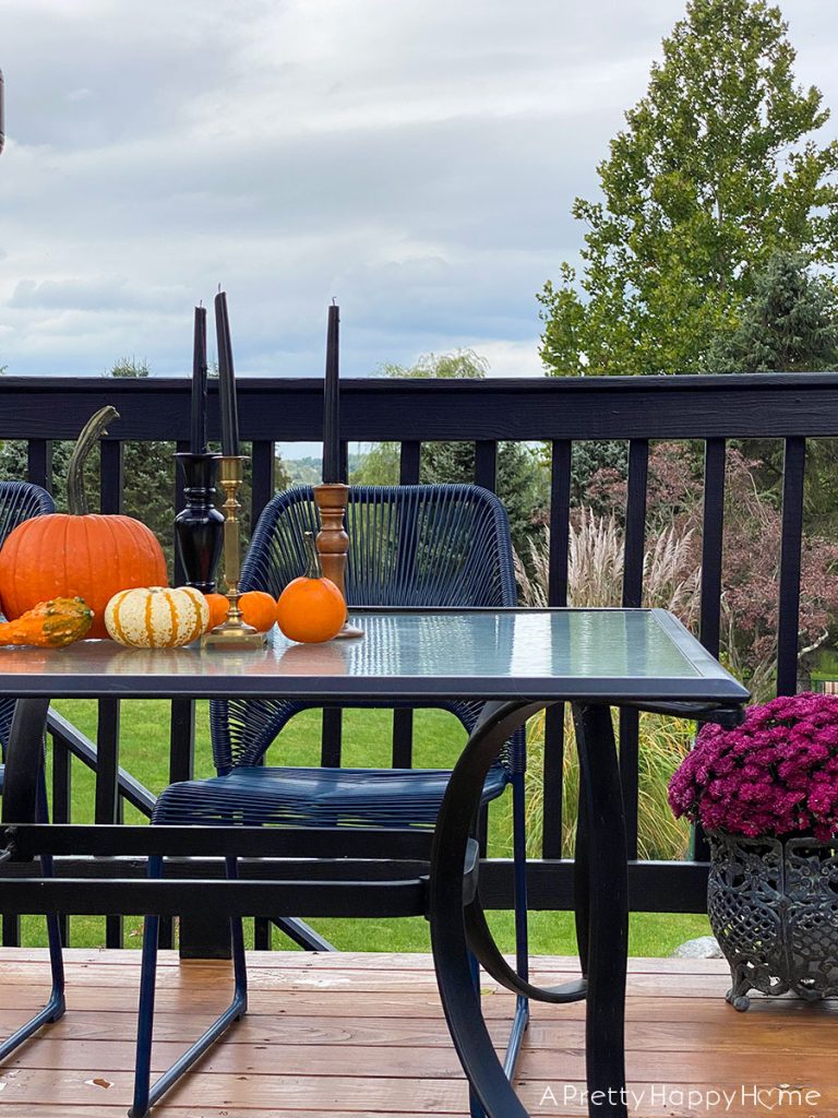 colonial farmhouse deck in fall black and blue outdoor furniture