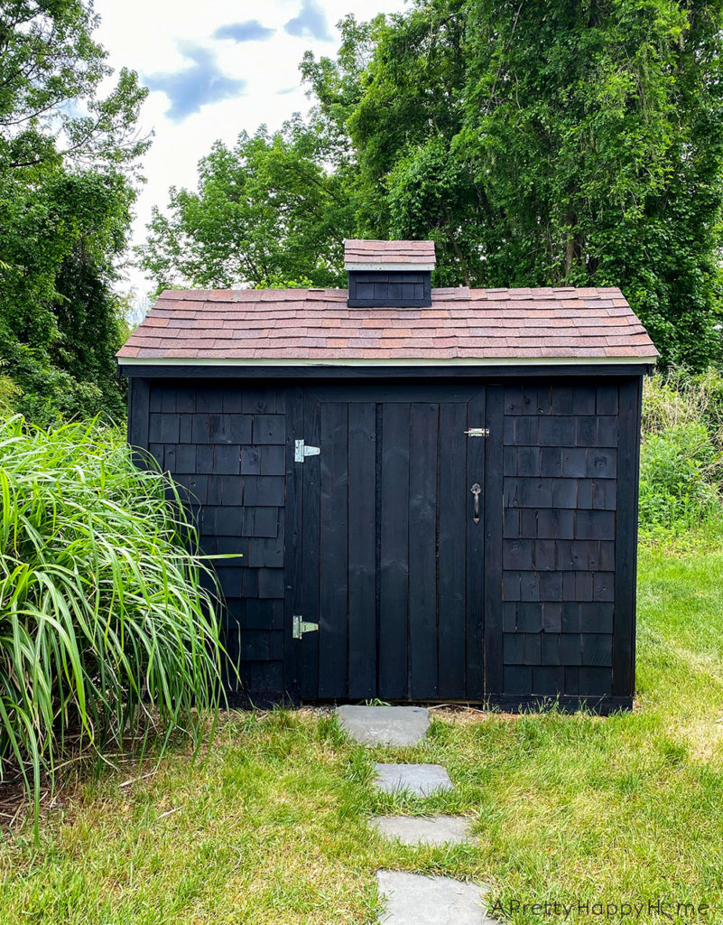 shed makeover with black stain
