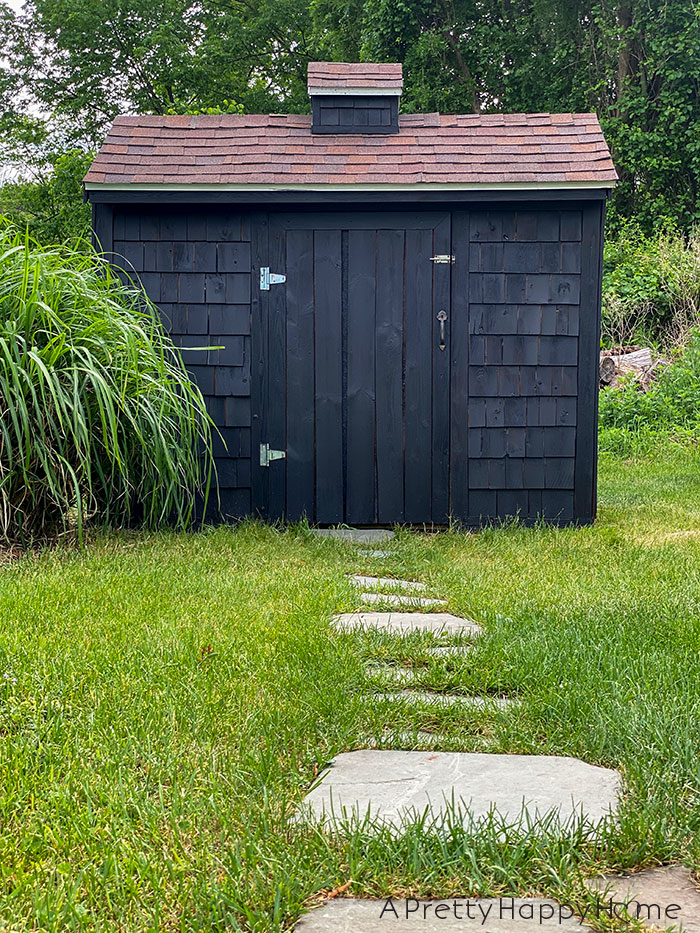 What Happens When You Set Flagstones Directly On The Ground or dirt shed makeover with black stain