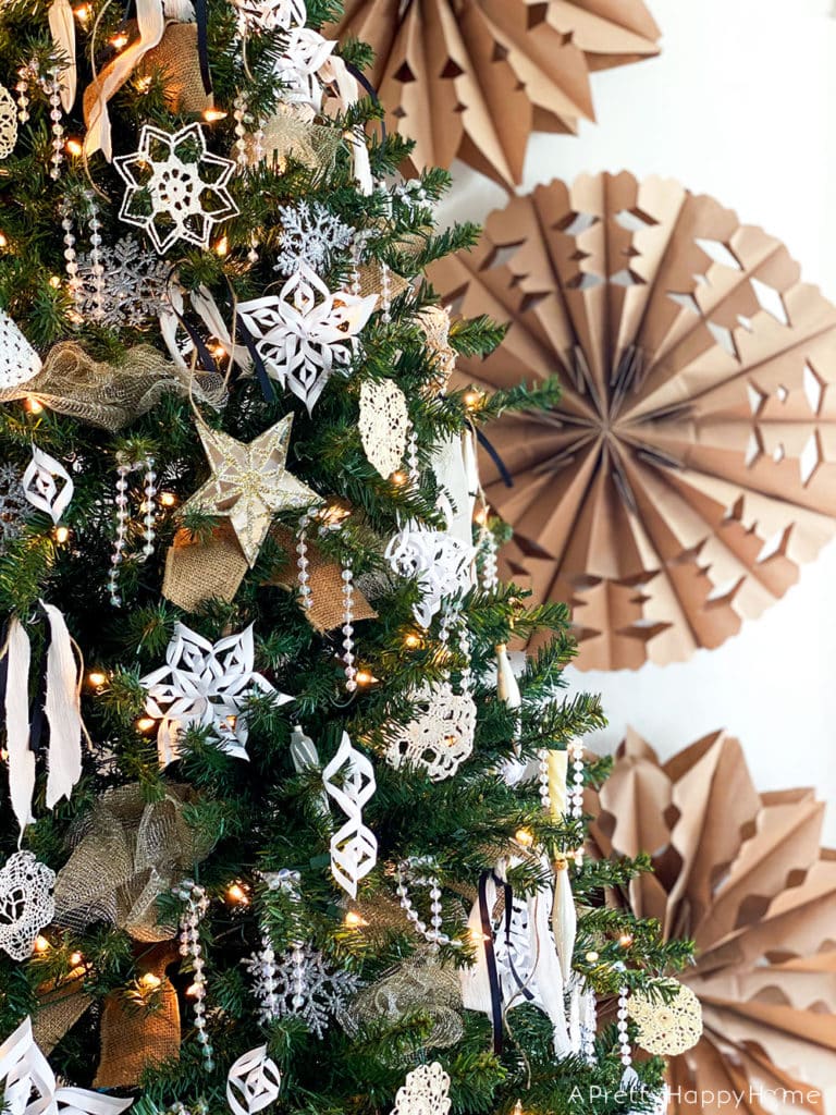 Inexpensive Christmas Tree Decorating Ideas use paper snowflakes to decorate a tree