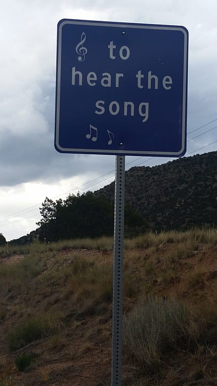 sign beside tijeras musical road via wikipedia by Devilstocksoup on the happy list