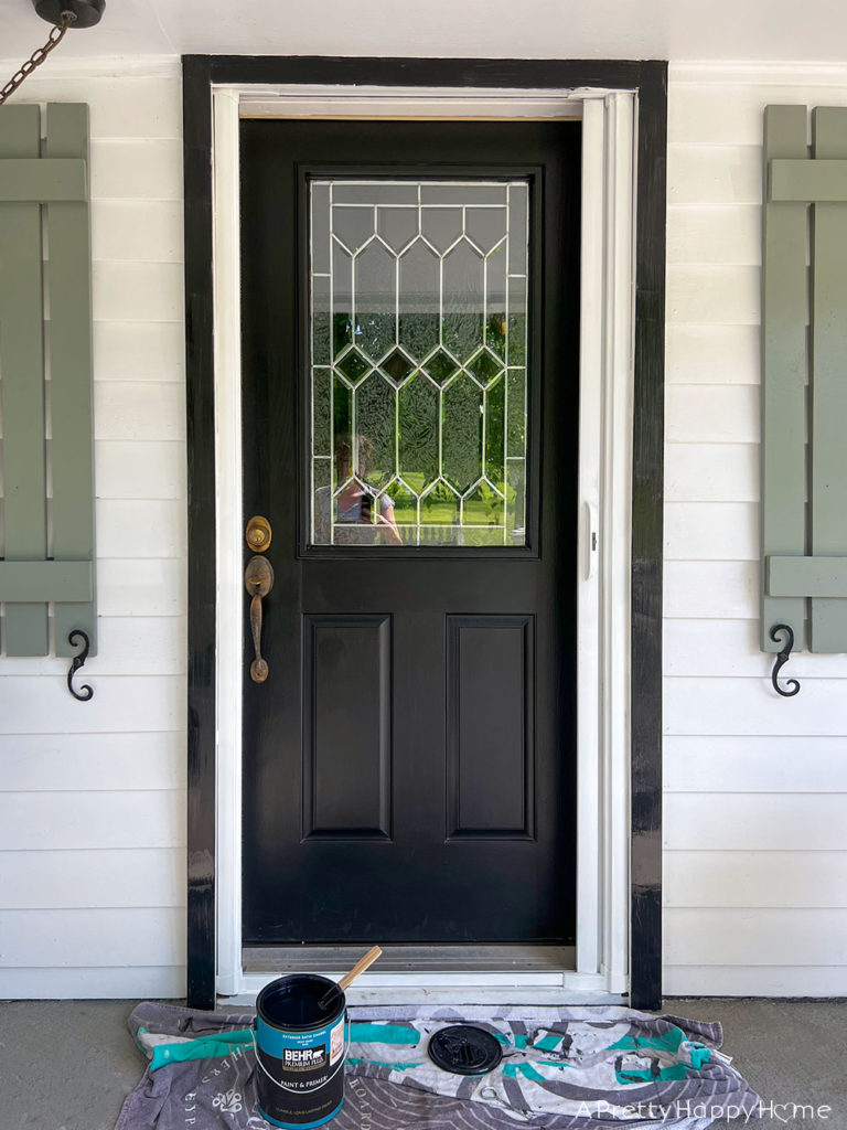 How We Made Our Front Door Look Bigger With Paint DURING painting door and trim same color to match and look bigger