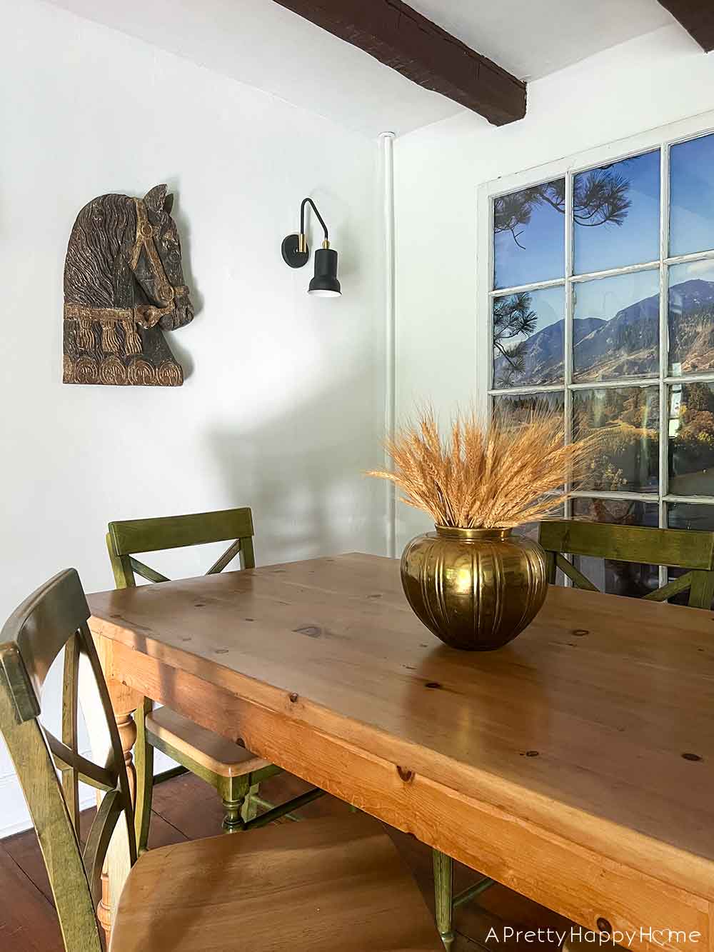 dried wheat in a gold vase in a farmhouse dining room