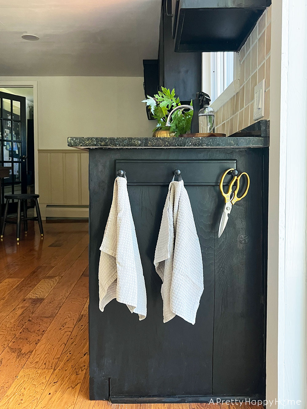 Kitchen Peg Rail Adds So Much Functionality black peg rail on black cabinets