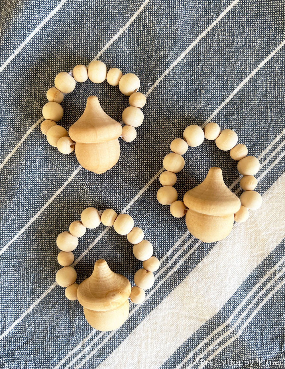 DIY Wood Acorn Napkin Rings how to make wood bead and acorn napkin rings fall napkin rings thanksgiving napkin rings