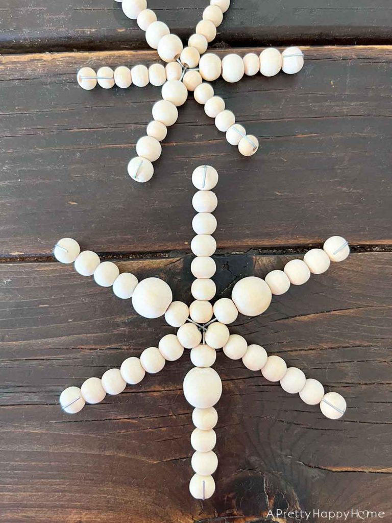 diy wood bead snowflake ornaments using a wire snowflake form