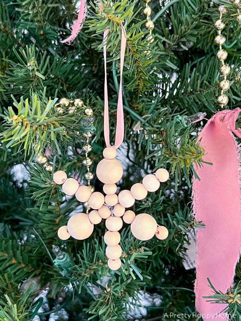 diy wood bead snowflake ornaments using a wire snowflake form
