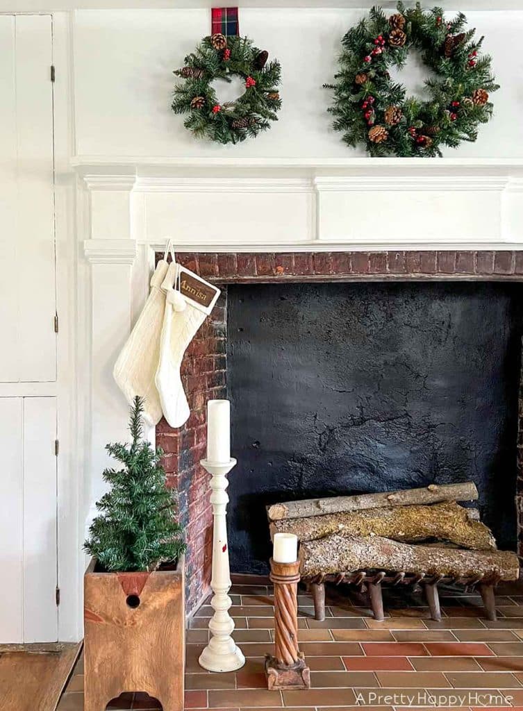 christmas mantel with three wreaths in a colonial era house