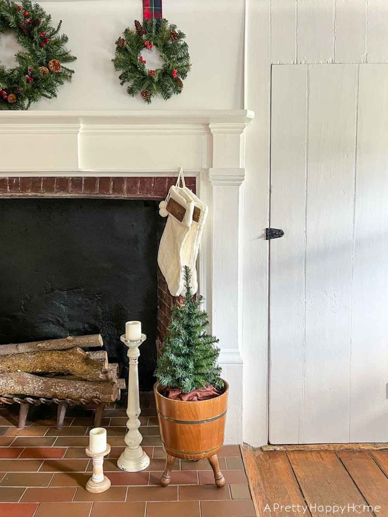 christmas mantel with three wreaths in a colonial era house