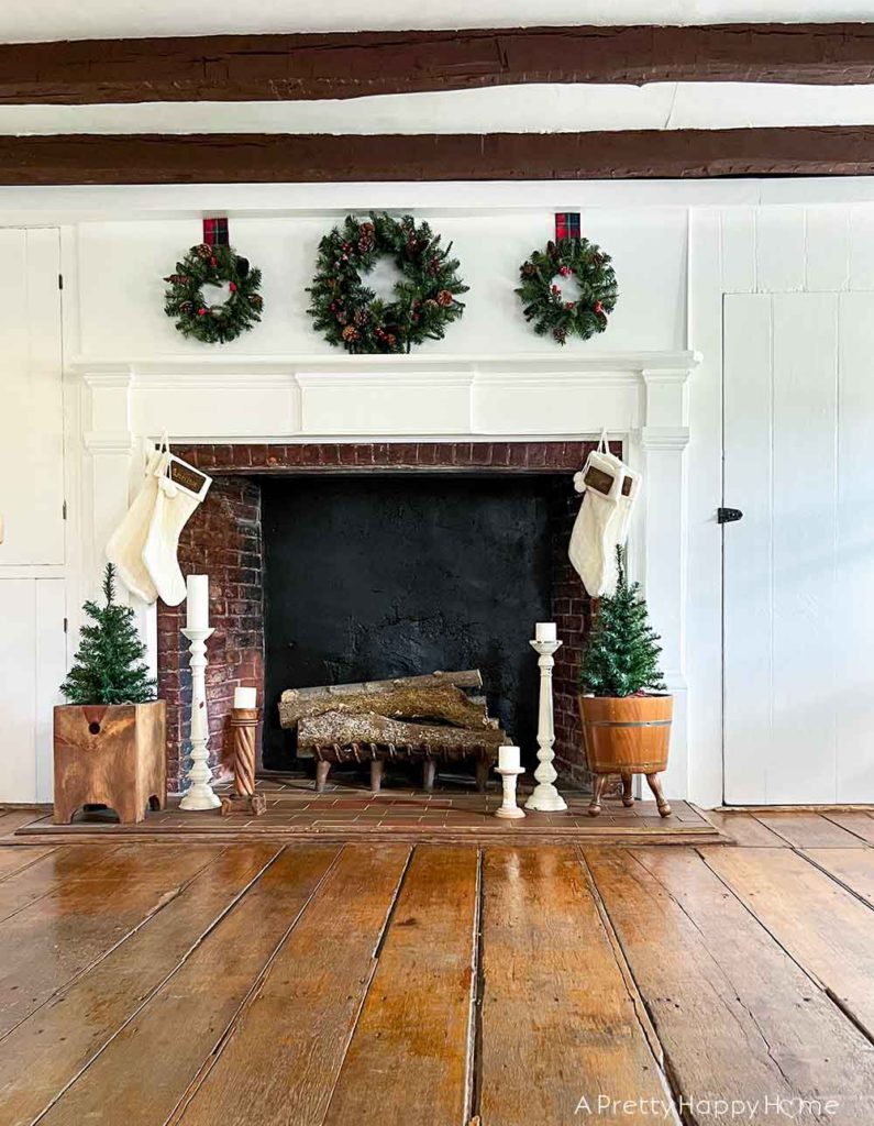 christmas mantel with three wreaths in a colonial era house