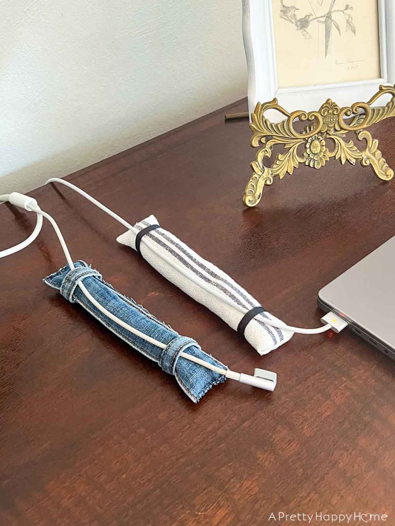 DIY weighted cord holder using rice and fabric to keep charging cords on a desk