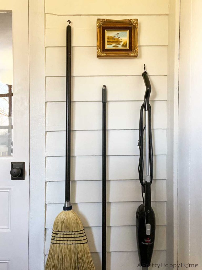 no utility closet space then make a utility wall to hang broom, mop, and vacuum