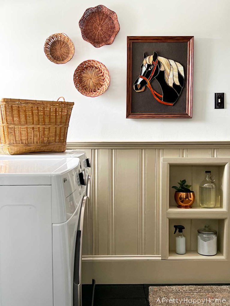 modern country laundry room in a colonial farmhouse with wainscoting stained glass horse art basket wall and inset wall shelves
