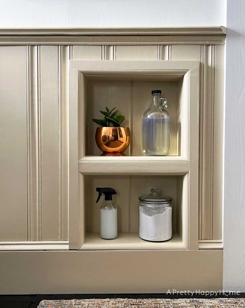 modern country laundry room in a colonial farmhouse with wainscoting stained glass horse art basket wall and inset wall shelves