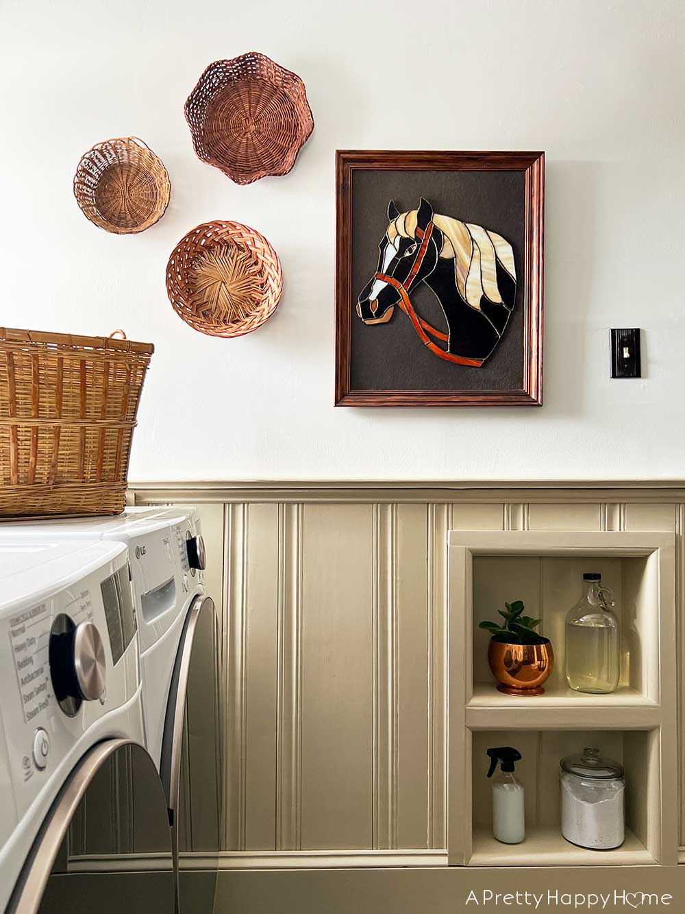 Colonial Farmhouse 5 Year Anniversary modern country laundry room with light tan wainscoting, horse art, and basket wall with built in niche.