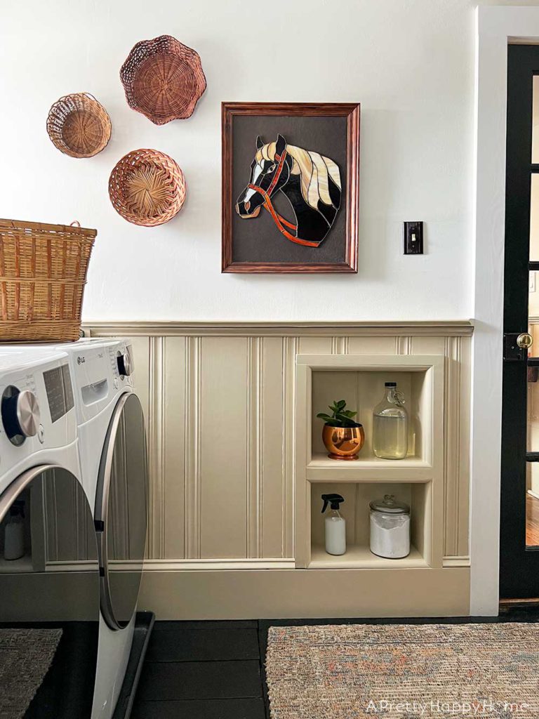 modern country laundry room in a colonial farmhouse with wainscoting stained glass horse art basket wall and inset wall shelves