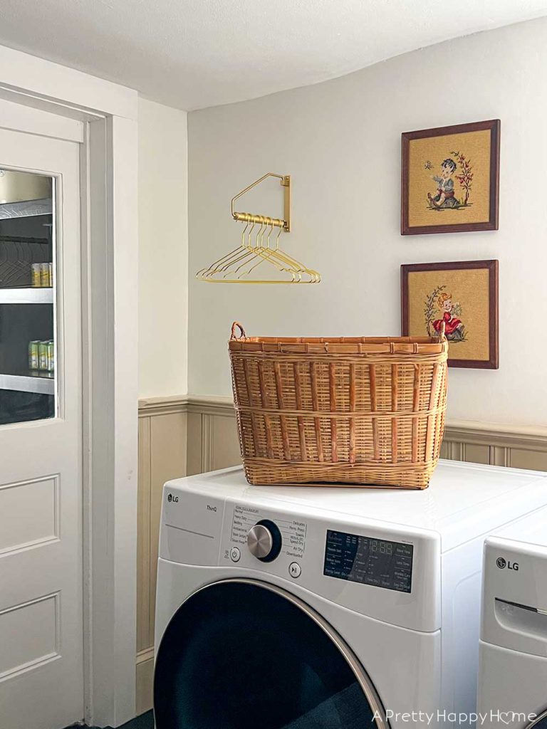 modern country laundry room in a colonial farmhouse with wainscoting stained glass horse art basket wall and inset wall shelves