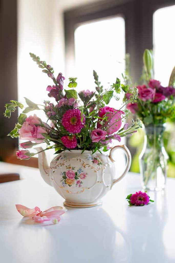 flower arrangement in a teapot by craftberry bush on the happy list