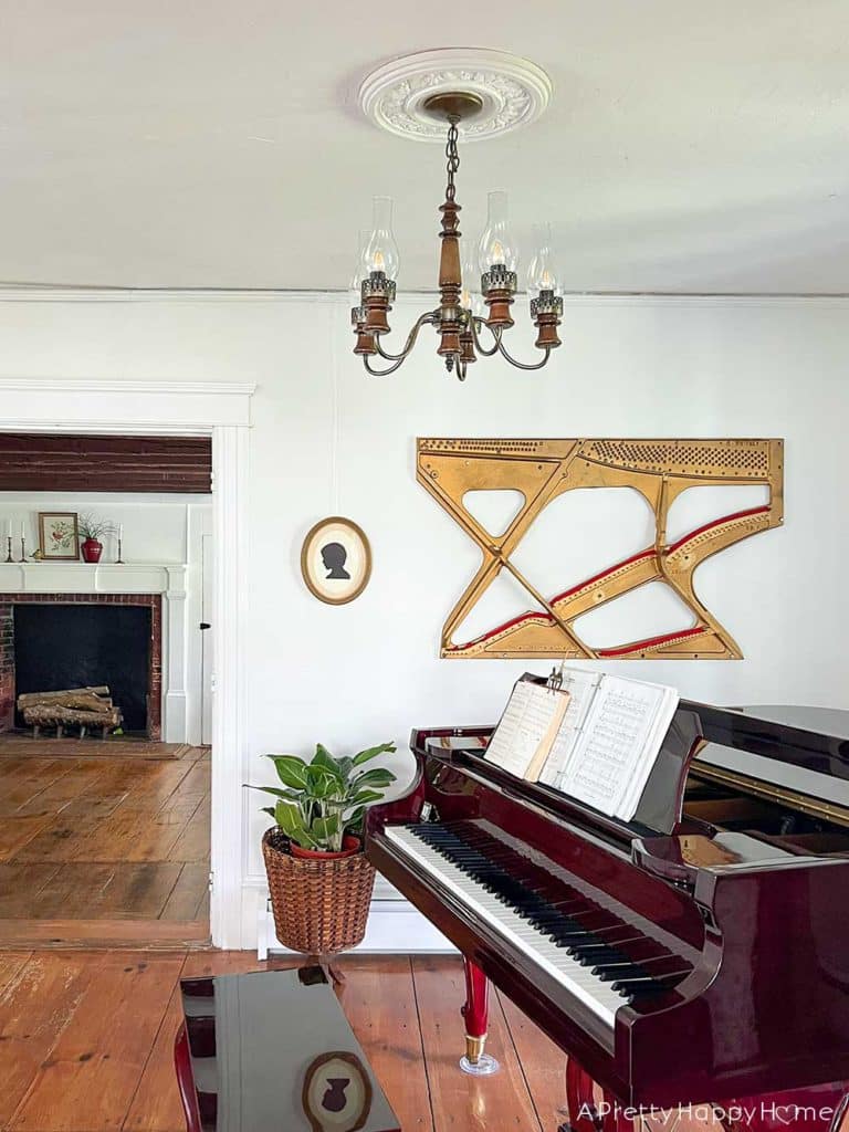 music room in a colonial farm house victorian era home with wood chandelier and ceiling medallion