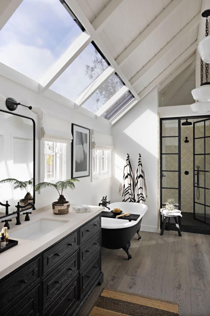 bathroom with slanted windows in ceiling designed by Raili CA Design via Desire to Inspire on the happy list