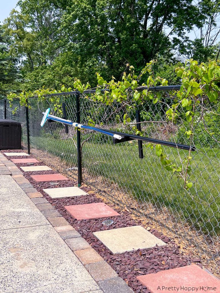 DIY Pool Maintenance Tool Holder For Leaf Skimmers and Poles DIY wood rack for holding leaf skimmers and telescoping poles around a pool