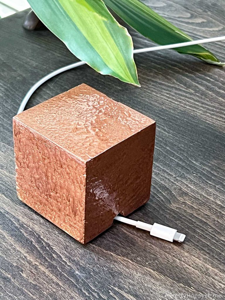 wood cube cord keeper painted with brush on hammered copper paint