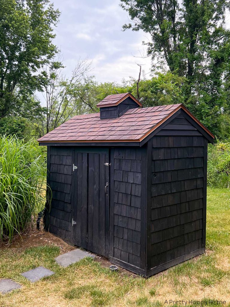 stained black shed with copper drip edge flashing the flashing is painted with hammered copper paint