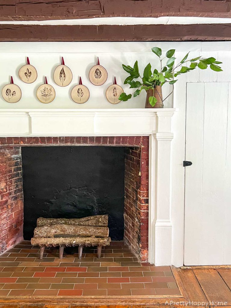 Fall Mantel With Leaf-Stamped Wood Rounds in a colonial era home with wood beams and original wood floors fall decorating ideas
