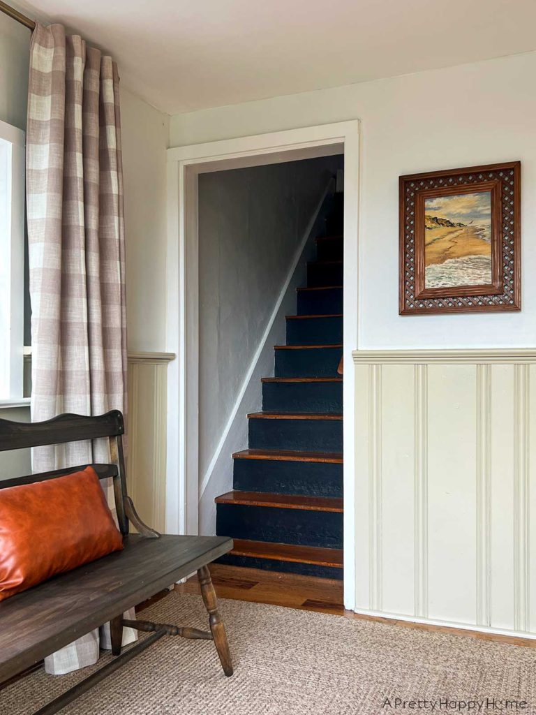 tan Buffalo Check Curtains in a farmhouse kitchen seating area with wainscoting