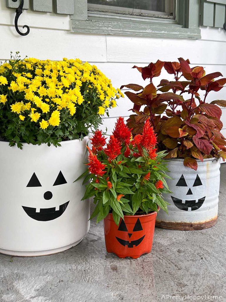 Our Fall Front Porch with a trio of jack o'lantern planters for halloween