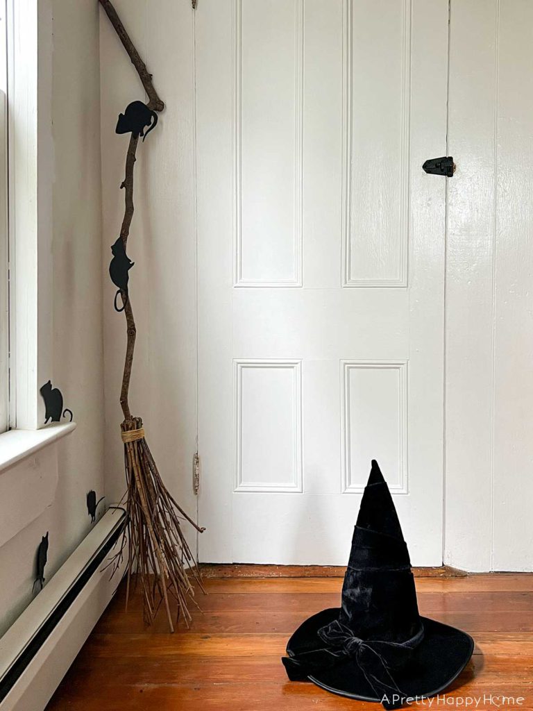 is our house haunted halloween vignette in an old home dating back to the 1700s with a witch broom and hat