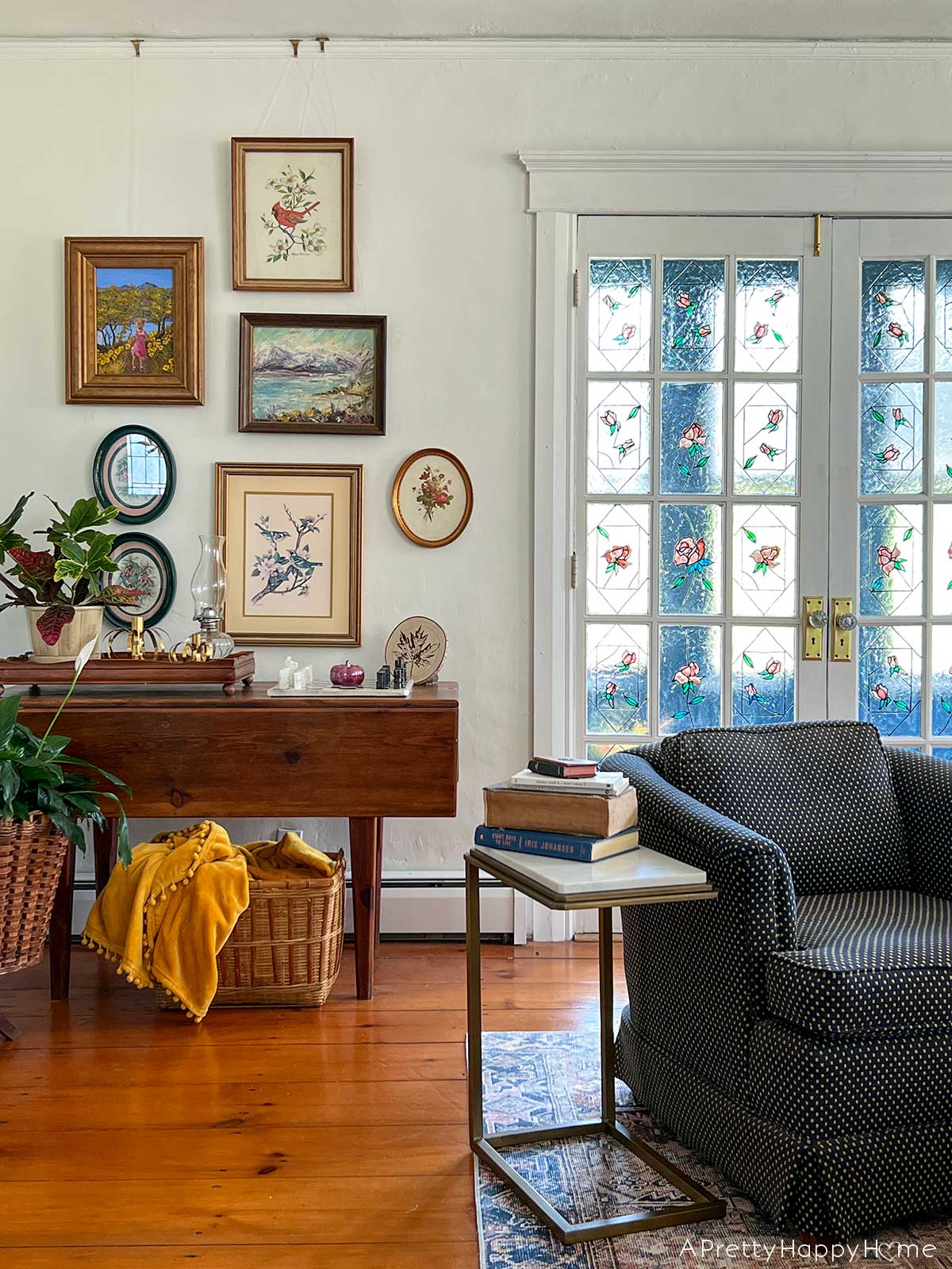 living room with stained glass windows, nature gallery wall and vintage ethan allen club chairs