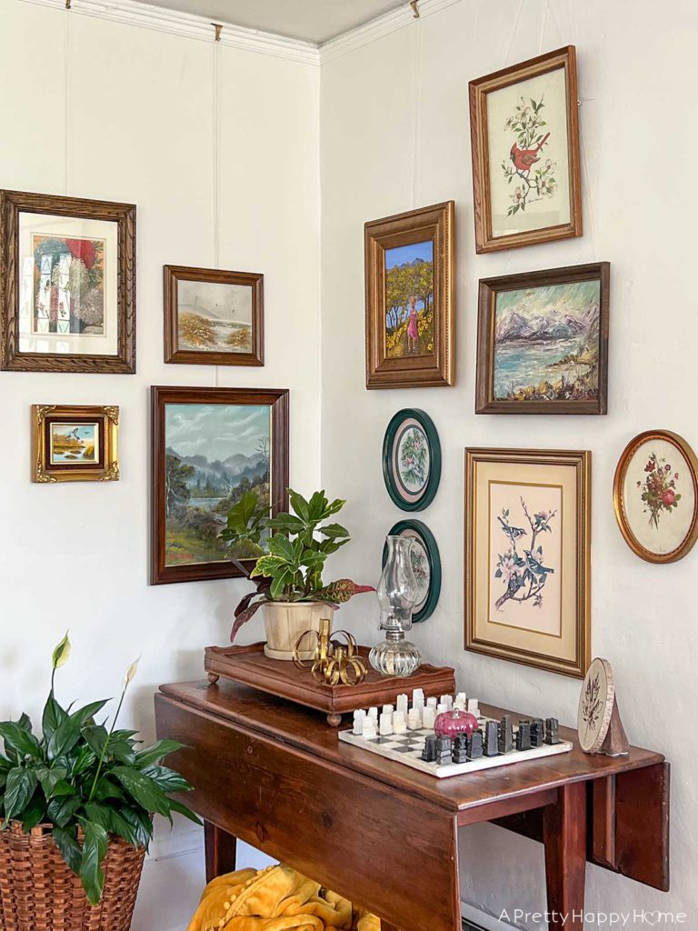 create a Nature Art Gallery Wall using an eclectic grouping of landscape art, flower prints, and leaf stamping.