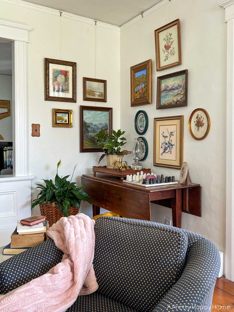 create a Nature Art Gallery Wall using an eclectic grouping of landscape art, flower prints, and leaf stamping.