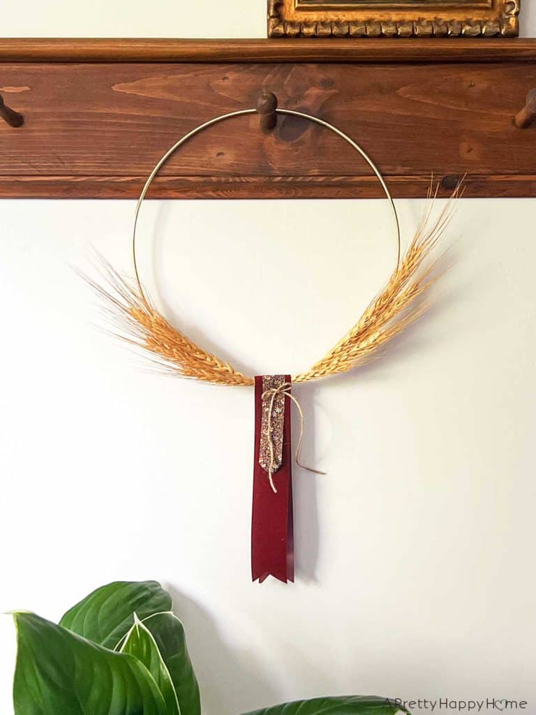 easy to make wheat wreath using a gold floral hoop, dried wheat and hot glue