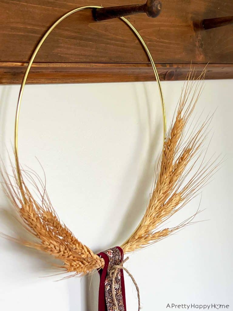 easy to make wheat wreath using a gold floral hoop, dried wheat and hot glue