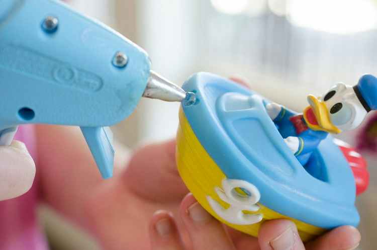 hot glue hacks use hot glue to plug hole on bath toys so they don't mold picture and tip from the krazy coupon lady on the happy list