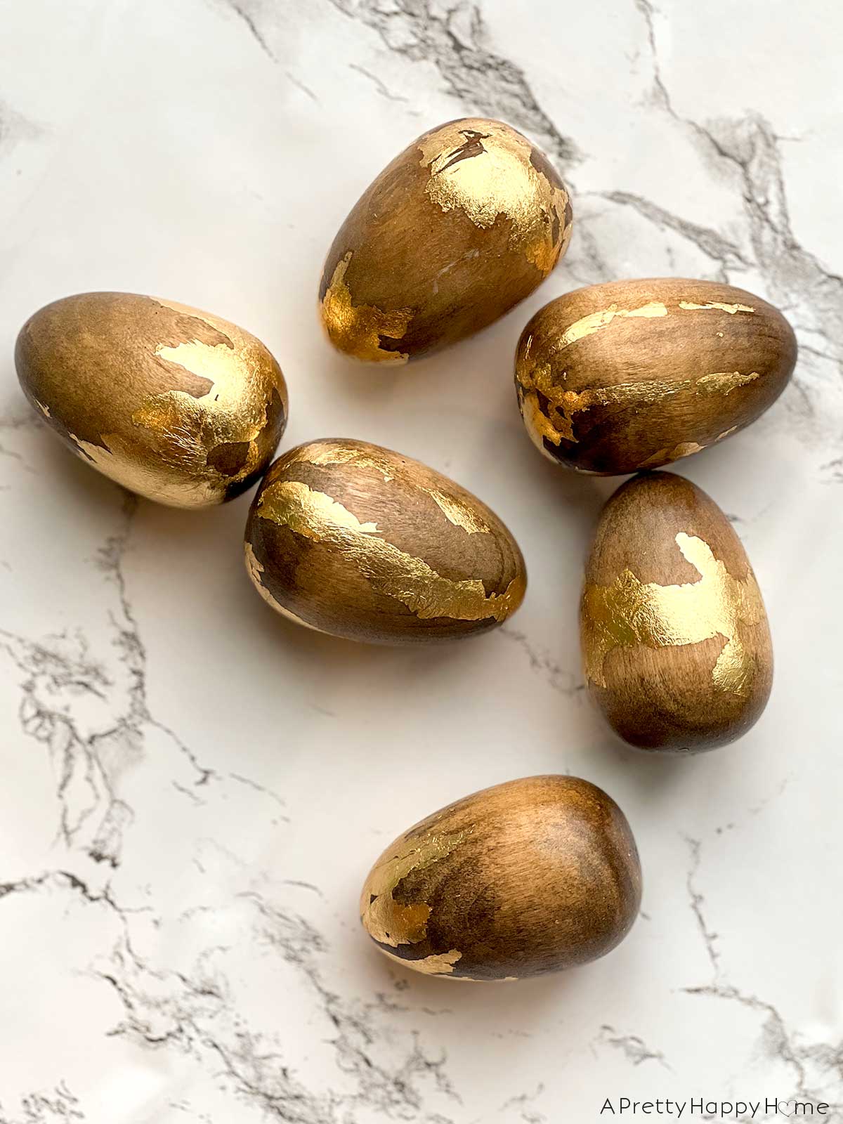 7 Ways To Decorate Wood Easter Eggs decorate wood easter eggs with stain and gold leaf
