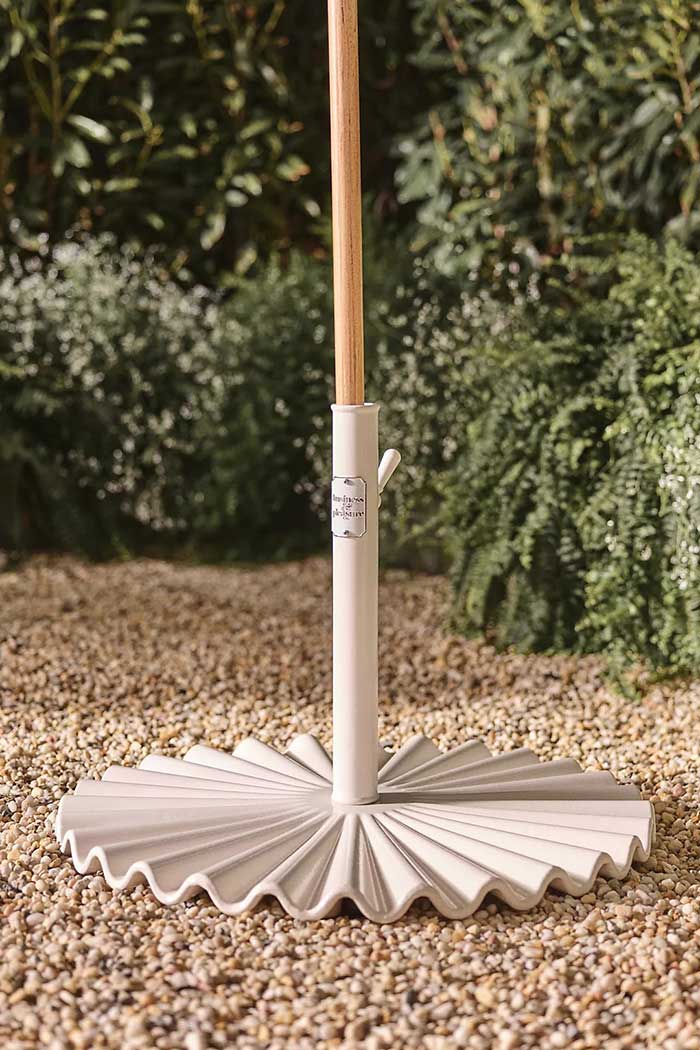 business and pleasure co clamshell umbrella base via anthropologie in praise of colorful patio umbrellas