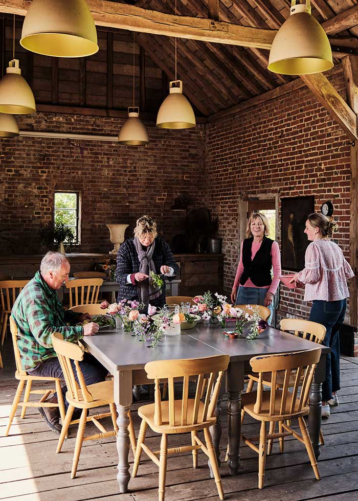sarah raven lifestyle brick room with double tables photo by dean hearne for house and garden uk on the happy list