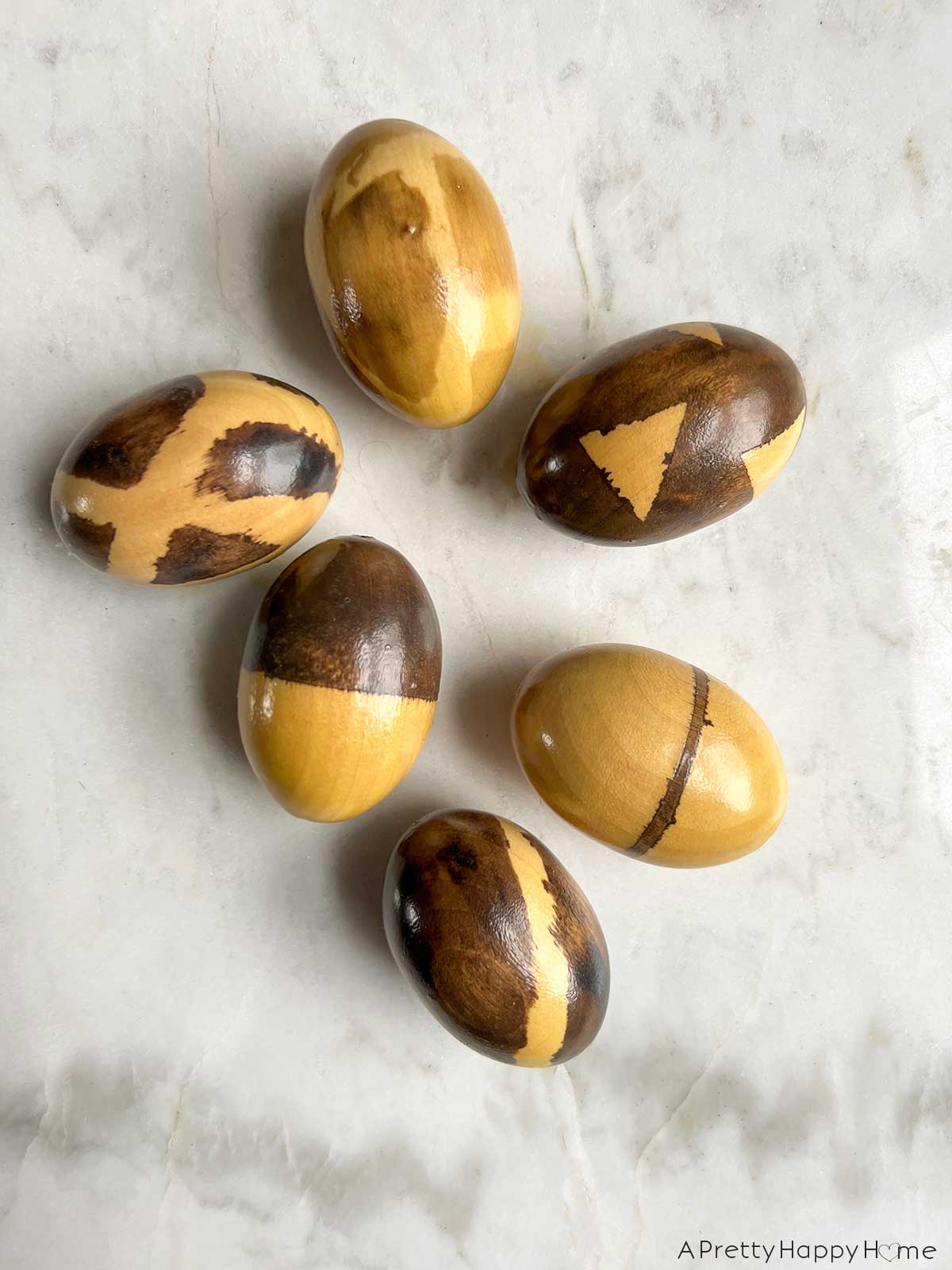 7 Ways To Decorate Wood Easter Eggs decorate wood eggs with painter's tape and stain or paint