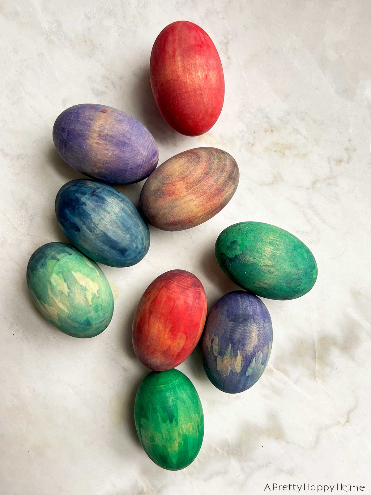 7 Ways To Decorate Wood Easter Eggs decorate wood eggs with watercolor paint or a paint wash so the wood grain still shows