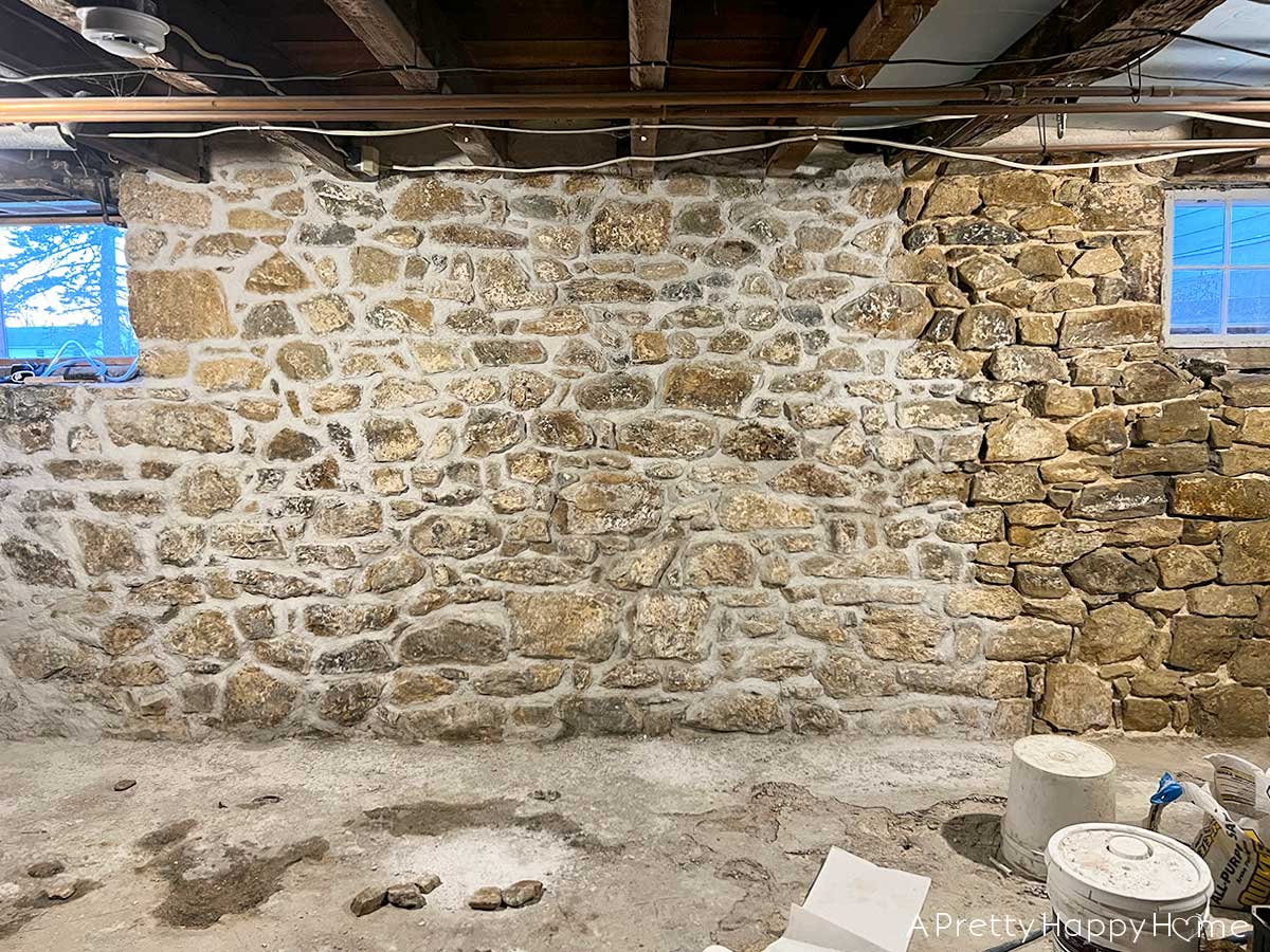 6 Things We Found Inside Our Stone Walls stone foundation being repointed inside a basement