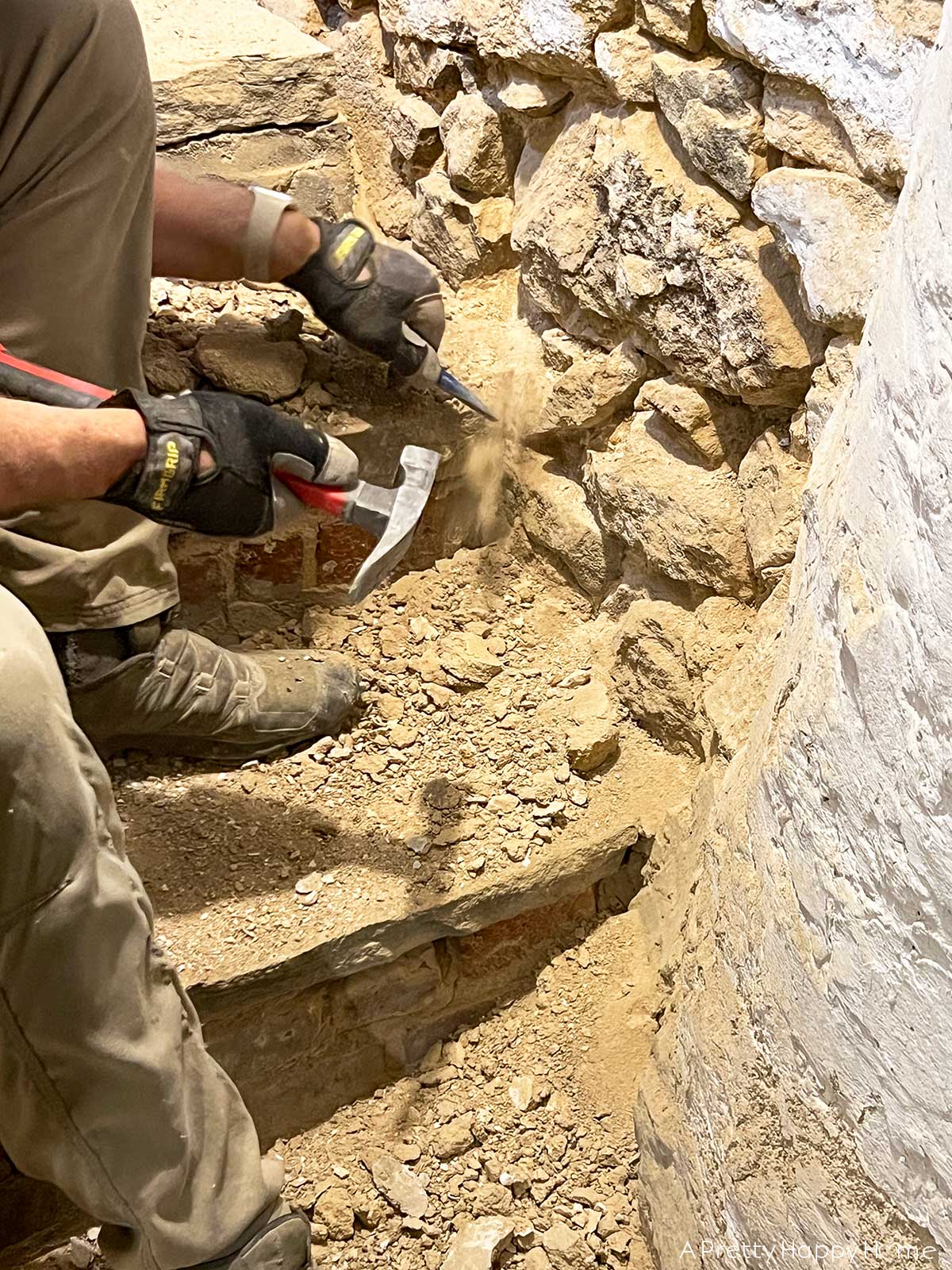 6 Things We Found Inside Our Stone Walls stone foundation being repointed inside a basement